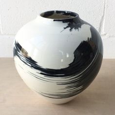 a black and white vase sitting on top of a table