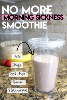 a smoothie in a plastic cup sitting on top of a counter