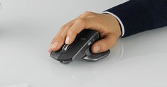 a person's hand on a computer mouse