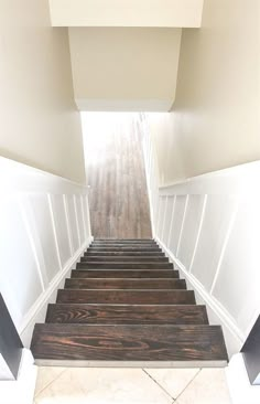 the stairs are made of wood and white paint