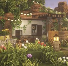 a house with lots of plants and flowers around it