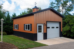 an orange and black garage with a clock tower on the top of it's roof