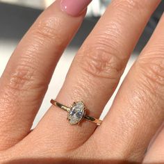 a close up of a person's hand with a ring on it