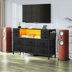 an entertainment center with speakers and a flat screen tv