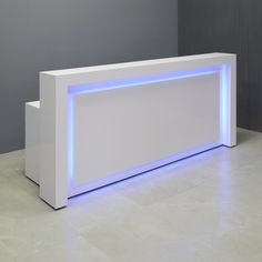 a white reception table with blue lights on the top and bottom shelf in front of it