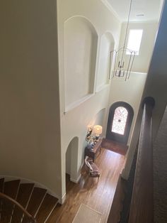 an aerial view of a staircase leading up to a window in a house with wood floors