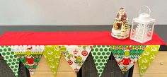 a red table topped with a christmas banner