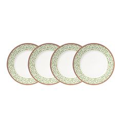 four green and white plates sitting next to each other