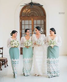 the bridesmaids are all dressed in green and white