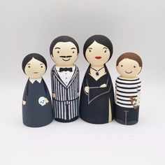 a group of wooden dolls standing next to each other in front of a white background