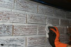 a brick wall that has been painted orange and white