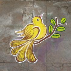 a yellow bird sitting on top of a tree branch with green leaves painted on it