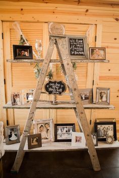 an old ladder is used as a shelf for photos