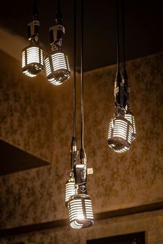 five lights hanging from a ceiling in a room