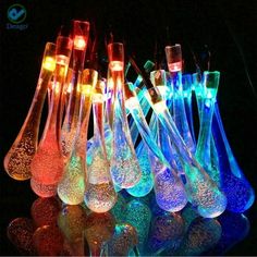 many different colored glass vases with lights in the bottom one is filled with liquid