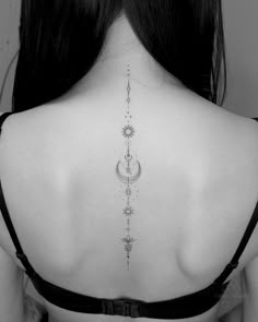 the back of a woman's neck with an intricate design on her left side