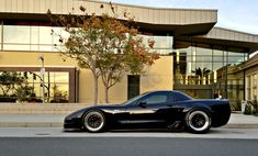 a black sports car parked in front of a building