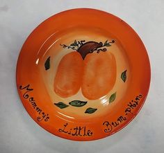 an orange plate with two little pumpkins on it that says mommy's little pumpkin