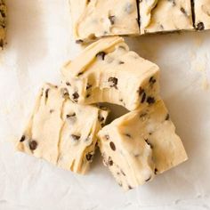 chocolate chip cookie dough cut into squares on a white surface