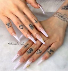 two hands with white nails and tattoos on them