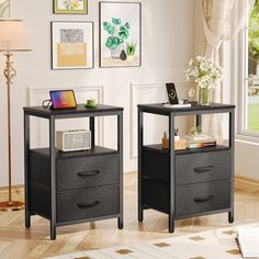 two black nightstands with drawers on each side in front of a white wall and windows