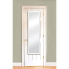 an empty room with a white door and mirror