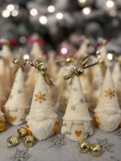 small white christmas trees with gold bells and bows