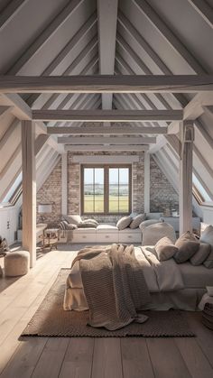 an attic bedroom with wooden floors and exposed ceilings, white walls and wood flooring