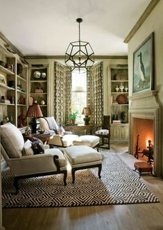 a living room filled with furniture and a fire place in the middle of a room