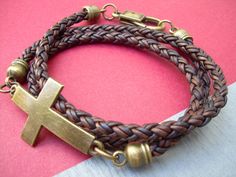 This triple wrap antique brown braided leather cross bracelet will symbolize your eternal love and commitment. For size reference, the cross measures 1 6/8 inches in length. Materials: Lead and Nickel Free - Antique Bronze Toned Alloy Metal Components, Fine Imported 5mm Leather Cord. The secure lobster clasp closure makes for a quick on and off. Each piece comes with a brand hang tag and a black drawstring pouch. Size: Available to fit a firm wrist measurement of 6/6.5/7/7.5/8/8.5 inches . Need Tab Crafts, Multi Wrap Bracelet, Leather Bracelets Women, Womens Bracelet, Mens Bracelets, Brown Leather Bracelet, Multi Strand Bracelet, Braided Leather Bracelet, Mens Leather Bracelet