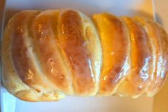 a close up of a doughnut in a box with glaze on it's edges