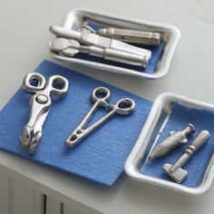 there are some scissors and other tools in the trays on the table, which is ready to be used