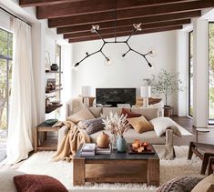 a living room filled with lots of furniture and decor on top of a white rug