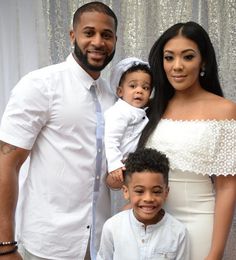 a man, woman and child posing for a photo