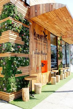 a wooden building with plants growing on it