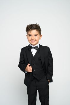 Tie Town takes the tie game to the next level with our drip and dapper formal wear sets!  Tie Town Boy's  suit collection consist of 5-pieces set : Jacket, Vest, Pants, Dress Shirt, and  Bow Tie or tie  Our 5-piece Boy's Suits dipper's your little gentleman right up!  Notch Lapel Jacket offers side vents for ventilation and comfort. Pants size match jackets Pants need to be hemmed to compliment his height. Waist size may be altered up to two (2) inches. Material content is Rayon blend with a Sup Fitted Suits With Ties For Black-tie Events, Fitted Black Suits With Ties, Black Fitted Suits With Ties, Elegant Black Suits With Ties, Elegant Black Suit With Ties, Fitted Business Sets With Ties, Black Suit With Ties For Formal Occasion, Formal Black Suits With Ties, Classic Black Suits With Ties