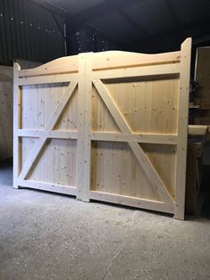 a large wooden gate in the middle of a garage