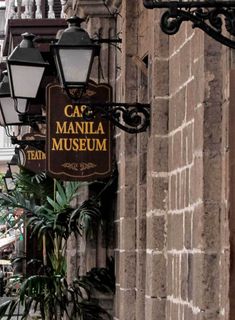 the sign on the building says ca'manlia museum in spanish and is hanging from the wall