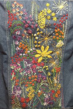 an embroidered denim jacket with flowers on it