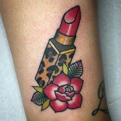 a tattoo on the leg of a woman with a red lipstick and leopard print tube