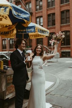 a man and woman standing under an umbrella