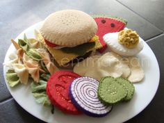 a white plate topped with sandwiches and veggies on top of a black table