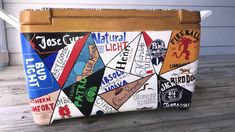 a wooden box that has various types of labels on it and is sitting on a porch