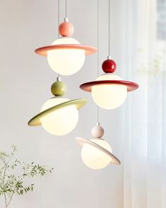 three different colored lights hanging from the ceiling