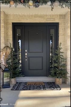 the front door is decorated with christmas trees