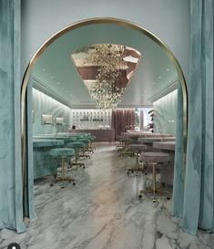 the interior of a fancy nail salon with marble floors and blue walls, chandeliers hanging from the ceiling