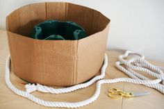 a brown bag sitting on top of a wooden table next to a pair of scissors