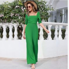 New Green Square Neck Short Sleeve Wide Leg Pant Jumpsuit This Womens Jumpsuits Features A Classic Square Neckline Adding A Touch Of Sophistication And Elegance To The Jumpsuit, Creating A Three-Dimensional And Layered Look That Is Sure To Turn Heads, While The Ruched Bodice Adds A Touch Of Glamour And Accentuates Your Curves. It's A Timeless Piece That Will Make You Stand Out. Wide Flowy Leg Short Sleeves Zipper Back Square Neckline Polyester And Elastane Size Large New Without Tags Fitted Wide Leg Jumpsuit Or Romper In Solid Color, Elegant Stretch Jumpsuits And Rompers For Spring, Elegant Stretch Jumpsuit For Spring, Fitted Green Jumpsuit, Chic Short Sleeve Jumpsuit For Brunch, Chic Short Sleeve Jumpsuits And Rompers For Brunch, Summer Beach Jumpsuits With Square Neck, Summer Beach Jumpsuits And Rompers With Square Neck, Green Stretch Jumpsuits And Rompers For Workwear