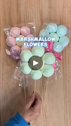 marshmallow flowers in cello bags on a wooden table with the words marshmallow flowers