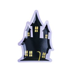 a paper cut out of a black and white house with yellow lights on the windows